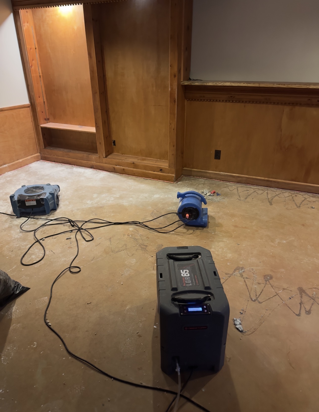 Water damage restoration equipment drying a damaged room