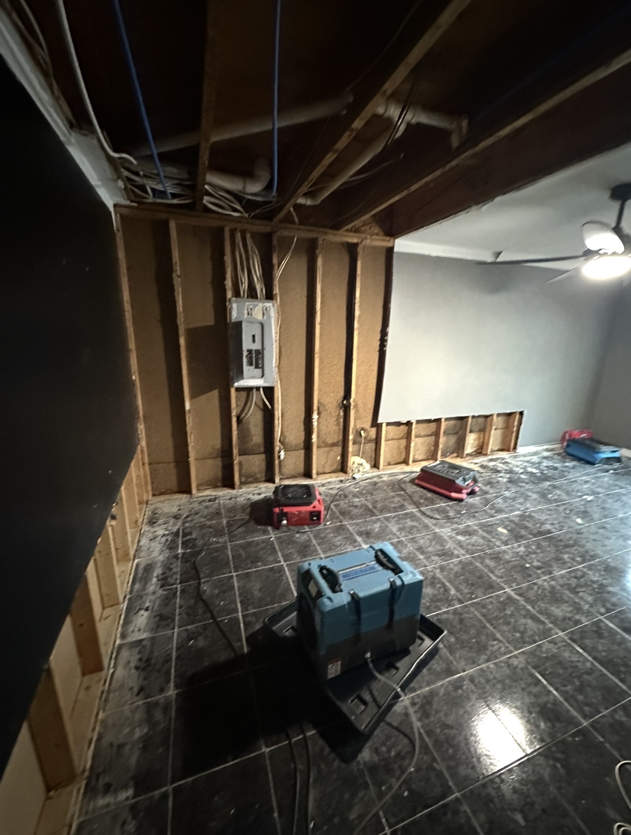 Water damage restoration equipment in a damaged room