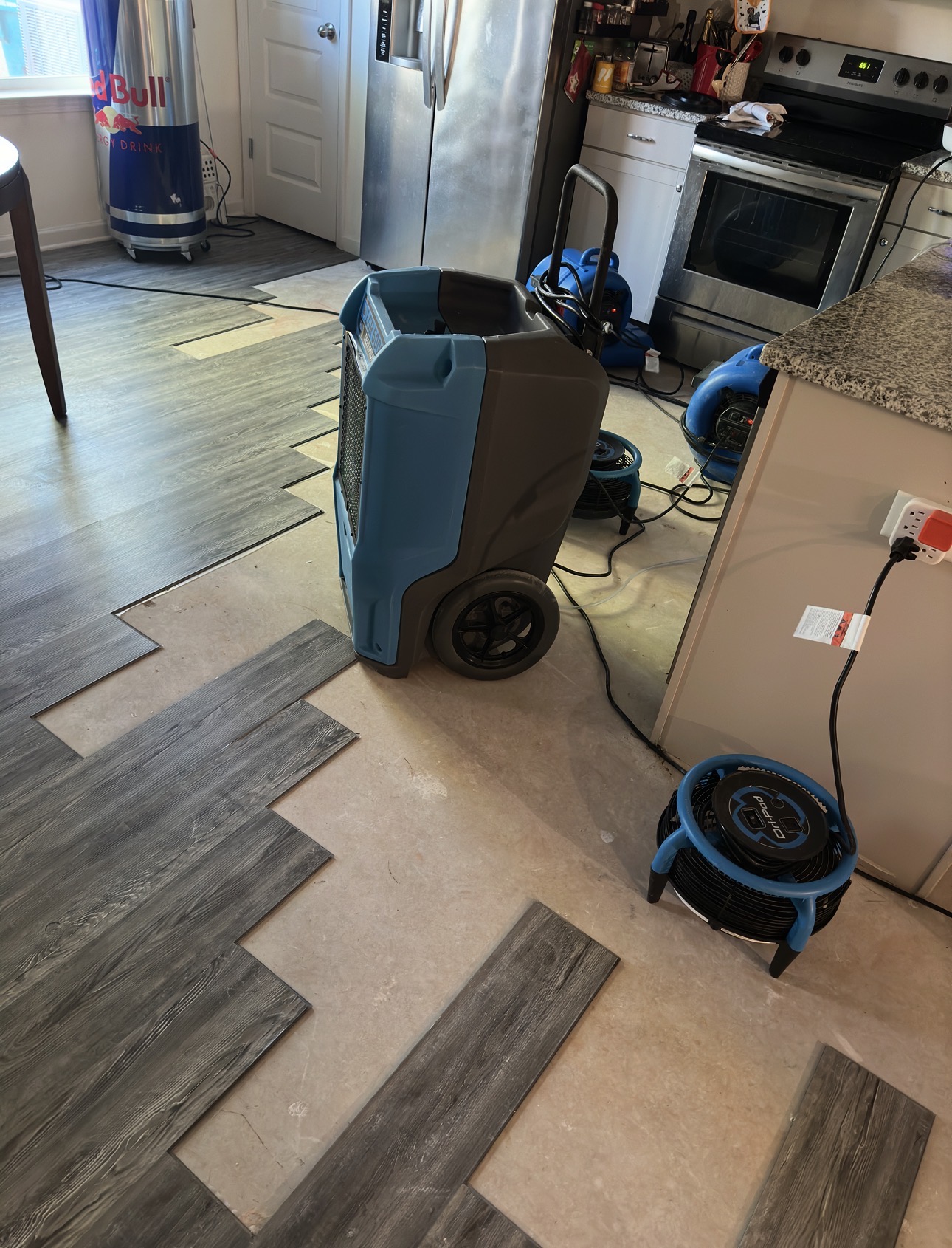 Water damage restoration equipment in a damaged room